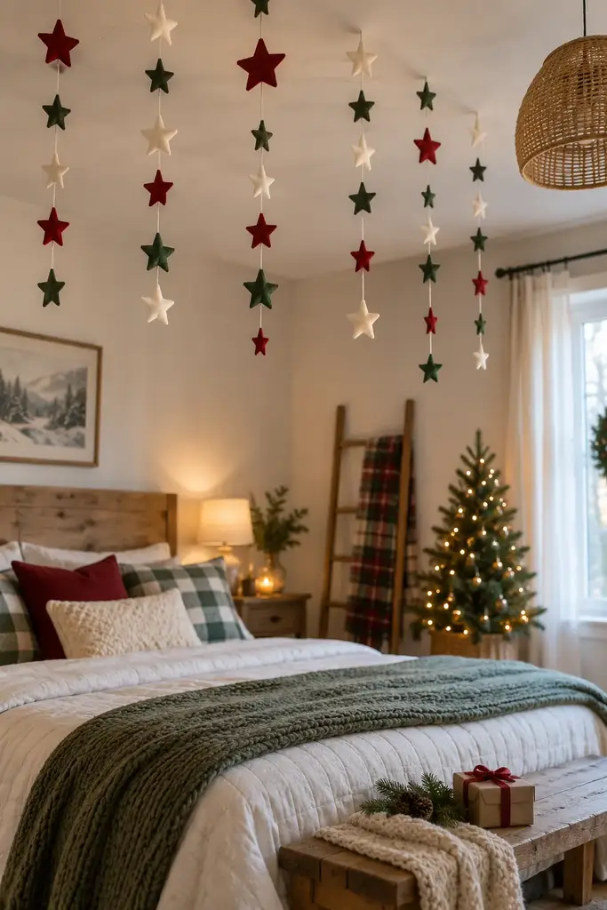 Red, green and cream felt stars hang in vertical strings near the foot of a bed